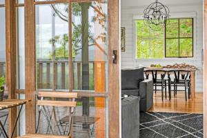 a living room and dining room with a dining table at Bellbird Lodge Barrington Tops in Bandon Grove