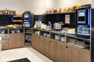 a kitchen with a counter with food on it at Hotel Khla Nice in Nice