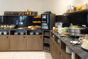 a kitchen with a counter with food on it at Hotel Khla Nice in Nice