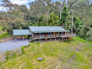 an aerial view of a house in the woods at Bellbird Lodge Barrington Tops in Bandon Grove