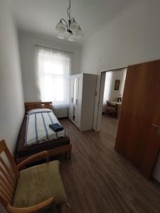 a bedroom with a bed and a chair and a window at Gerald´s Apartment 19 in Vienna