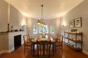 a dining room with a table and some chairs at Ama Stays and Trails Tea Estate Bungalows , Munnar in Munnar
