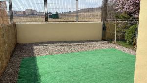 a green floor in front of a fence at Casa Valero in Rubielos de Mora