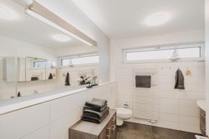 a bathroom with a toilet and a sink at Penthousewohnung Bockhorn in Bockhorn