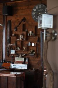 a room with wooden walls and a clock on the wall at Villa Le Chocolate in Vrasná