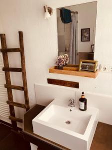a bathroom with a white sink and a mirror at [E] ifeel home_ Adenau in Adenau +13 photos