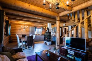 a living room with a television and a dining room at Bosorka Apartments Zrub Mara in Liptovský Trnovec