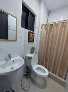 a bathroom with a white toilet and a sink at Regal425 Condotel in Angeles