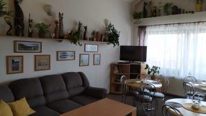 a living room with a couch and a table at Penzion Demi in Stará Lesná