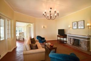 a living room with a couch and a fireplace at Ama Stays and Trails Tea Estate Bungalows , Munnar in Munnar