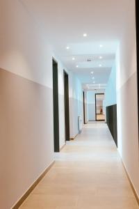 an empty corridor of an office building with white walls at FirstSleep Landshut in Landshut