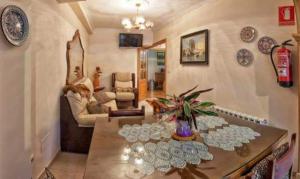 a living room with a table with plates on it at Albergue de Peregrinos Ultreia et Suseia in Sigüeiro