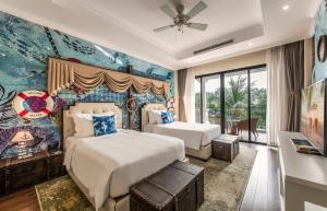 a hotel room with two beds and a window at Vinpearl Wonderworld Phu Quoc in Phu Quoc +195 photos