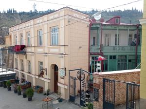 an apartment building in a city with a balcony at La Maison #7 in Tbilisi City
