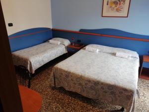 Postel nebo postele na pokoji v ubytování Hotel Trifoglio