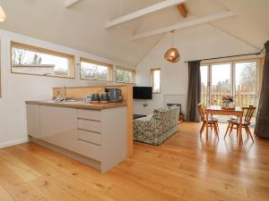 a kitchen and living room with a table and chairs at The Beehive in Exeter
