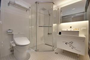 a bathroom with a shower and a toilet and a sink at Forward Hotel Taipei Nangang in Taipei