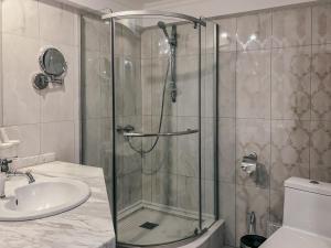 a bathroom with a shower and a sink at Shiny River Hotel in Ustʼ-Kamenogorsk +30 photos
