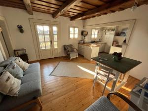 a living room with a couch and a table at Weingarten Lodge in Winten