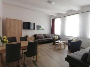 a living room with a couch and a table at Ferienwohnung Neuer Weg 15 in Quedlinburg