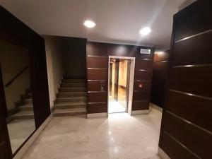 a hallway with stairs and a door in a building at Appartamento del Parco in Lunghezza