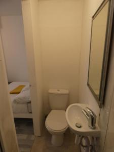a small bathroom with a toilet and a sink at Bridge Street Studio Room in Merthyr Tydfil