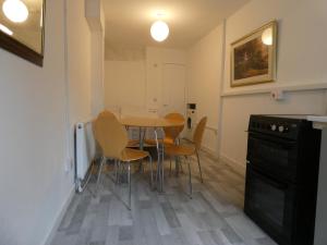 a kitchen and dining room with a table and chairs at Bridge Street Studio Room in Merthyr Tydfil
