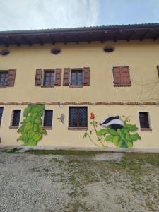 un edificio con una pintura a un lado. en B&B Naturin - Cascina Colombaro, en Lauriano