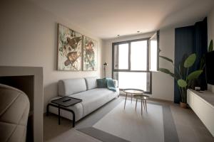 a living room with a couch and a table at VV Luxury Tropical Blue "by henrypole home" in Las Palmas de Gran Canaria