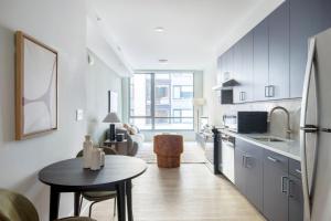 a kitchen with a table and a small kitchen with a table at NoMa 1br w wd concierge gym nr Metro WDC-648 in Washington