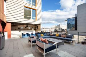 a patio with a couch and chairs on a building at NoMa 1br w wd concierge gym nr Metro WDC-648 in Washington