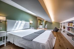 a bedroom with a large white bed in a room at YiD Capo di Mondo Luxury apartment in florence in Florence