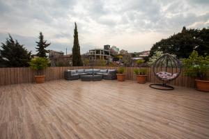patio con divano e sedia su una terrazza in legno di Terrace View a Tbilisi City