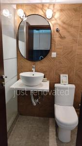 a bathroom with a sink and a toilet and a mirror at City Center Fresh Studio #Self Check In# in Thessaloniki