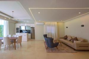 a living room and dining room with a couch and a table at Selena Bay Resort & Beach Club in Hurghada