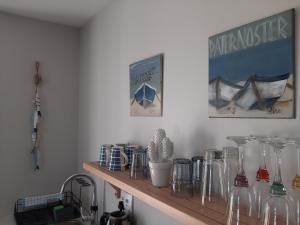 a shelf filled with glass vases on a wall at Milk Thistle Loft & Studio apartments in Paternoster