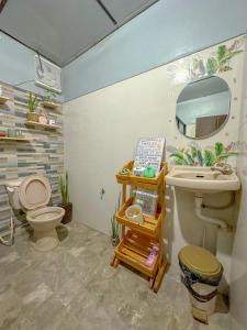 a bathroom with a sink and a toilet at Remy's Nest in Tagaytay