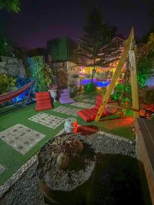 a backyard with a hammock and a garden at night at Remy's Nest in Tagaytay