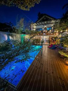 a house with a swimming pool at night at Remy's Nest in Tagaytay