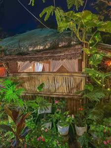 a bird house in a garden with plants at Remy's Nest in Tagaytay