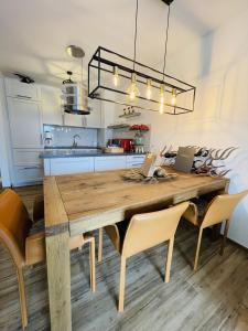 a dining room with a wooden table and chairs at Neue Ferienwohnung mit Whirlpool und Sauna in der Residenz Grafenmatt inklusive HochschwarzwaldCard in Feldberg