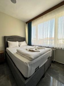 a large bed in a bedroom with a large window at HİSAR HOTEL in Istanbul
