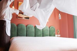 a bedroom with a bed with a green head board at Margot Old Tbilisi in Tbilisi City