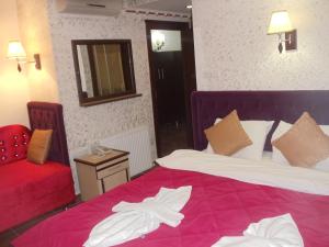 Postel nebo postele na pokoji v ubytování Ares Hotel