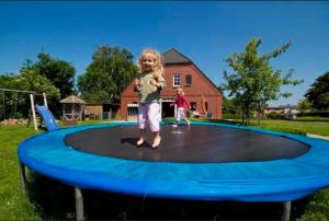 a little girl standing on a trampoline at Hein Sonnenschein in Wulfen auf Fehmarn