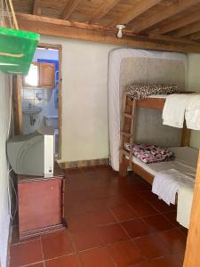 a room with two bunk beds and a mirror at alojamiento rural finca ayapel in Verdún