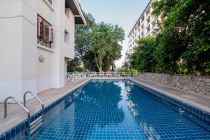a swimming pool next to a building at Hillside Resort in Pattaya Central