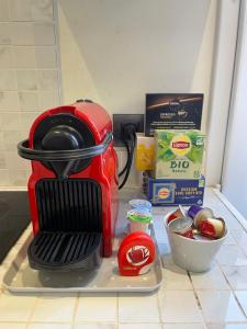 a kitchen counter with a red coffee maker and ingredients at Cap d ail 2 pièces proches Monaco et plage in Saint-Antoine