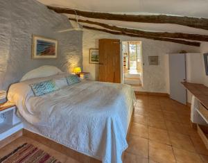 a bedroom with a large bed in a room at Wonderful comfortable finca in the Burga valley in Rasquera
