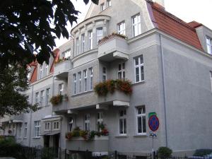 a building with flower boxes on the side of it at Apartamenty i pokoje przy sopockim molo in Sopot
